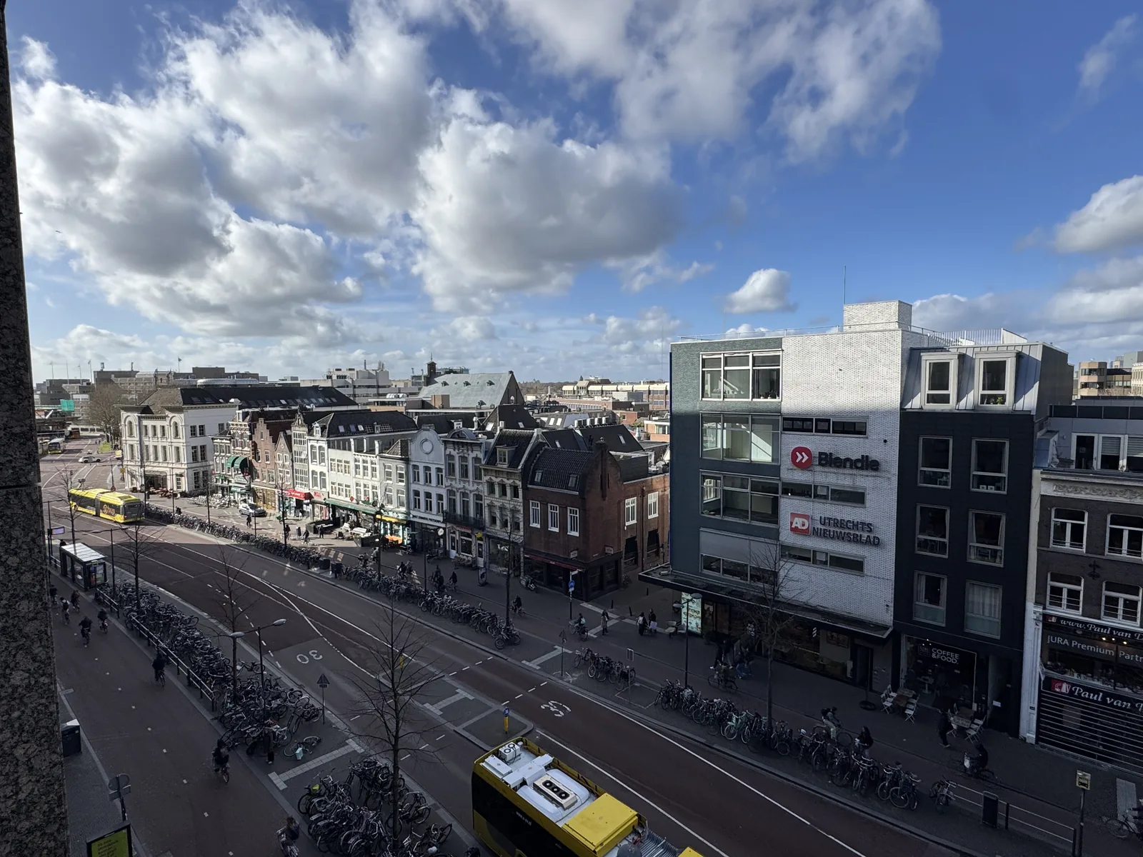 Aerial view from apartment balcony of Vredenburg square with tram, cyclists, and historic Utrecht buildings