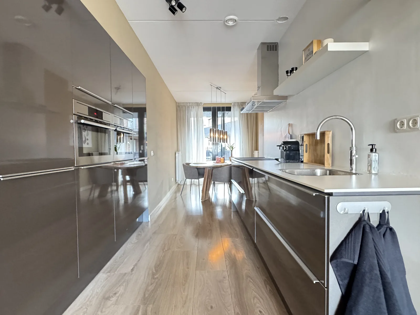 Modern kitchen with built-in oven and sleek grey cabinets in furnished Utrecht rental